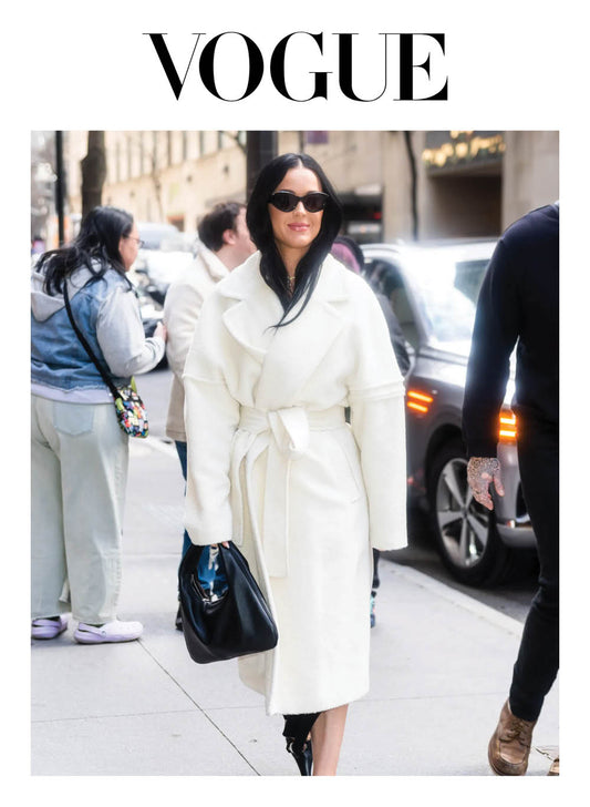 Image features the Vogue logo and an image of Katy Perry wearing the Sentaler Technical Bouclé Alpaca Robe Coat featured in Technical Bouclé Alpaca and available in Ivory White. 