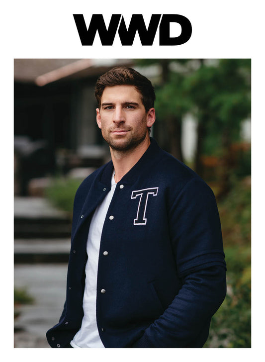 Image features the WWD logo and an image of Image features the Fashion logo and an image of Toronto Maple Leafs Captain, John Tavares wearing the SENTALER x John Tavares Varsity Jacket in Technical Baby Alpaca in Deep Navy.
