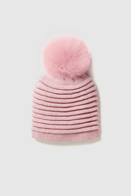 Sentaler Adult Ribbed Hat With Oversized Fur Pompon featured in Baby Alpaca and available in Pink. Seen as off figure.