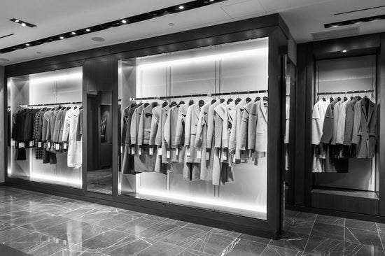 Image of the women's and men's coats on the racks at the Sentaler Atelier Showroom in Yorkville. Seen in black and white.