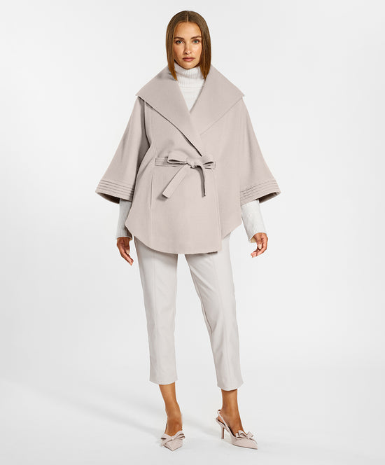 Sentaler Cape with Shawl Collar and Belt crafted in Baby Alpaca and in Bleeker Beige. Seen from front on female model.