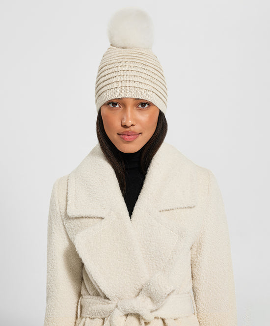 Sentaler Adult Ribbed Hat With Oversized Fur Pompon featured in Baby Alpaca and available in Ivory. Seen from front on model.