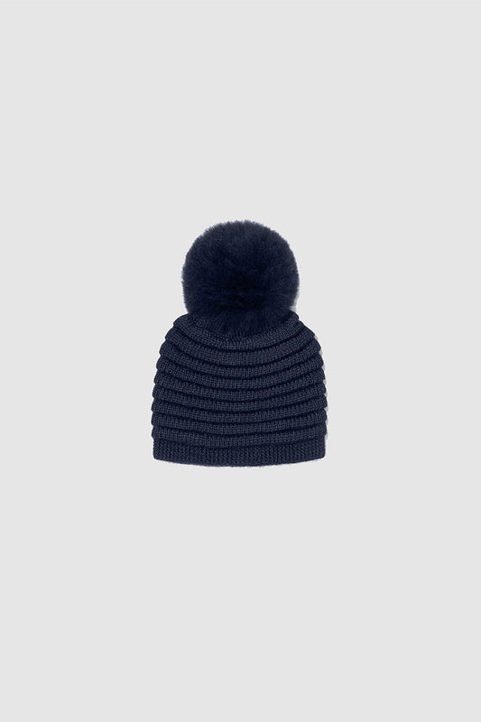 Sentaler Kids (1-5 Years) Ribbed Hat with Oversized Fur Pompon featured in Baby Alpaca and available in Navy Blue. Seen as off figure.