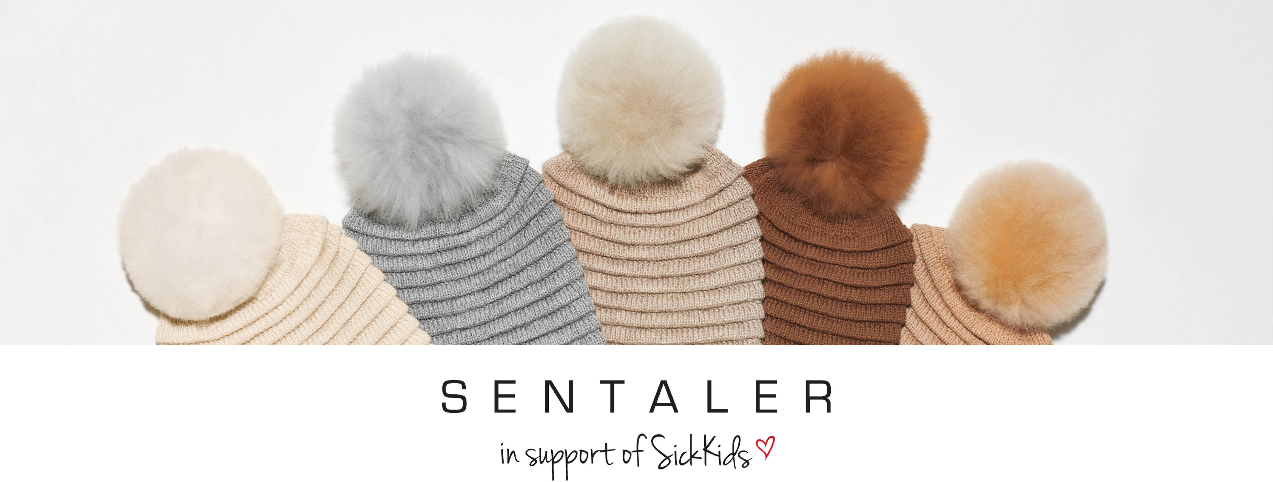 Sentaler 2021 Gift Guide featuring Close up of Women's Adult Ribbed Hat with Oversized Fur Pompon in Assorted Neutral Colours.
