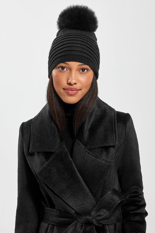 Sentaler Adult Ribbed Hat With Oversized Fur Pompon featured in Baby Alpaca and available in Black. Seen from front on model.