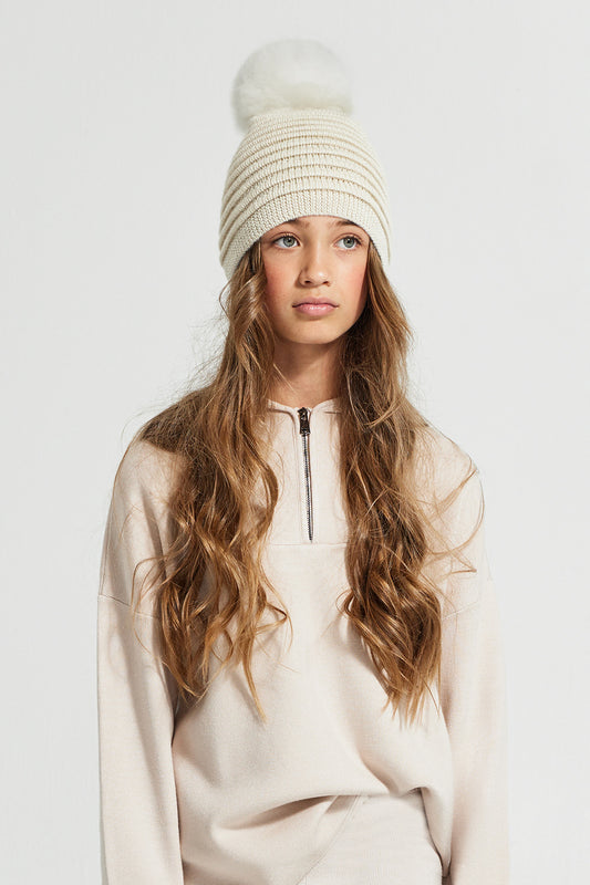 Sentaler Kids (6-14 Years) Ribbed Hat with Oversized Fur Pompon featured in Baby Alpaca and available in Ivory. Seen from front.